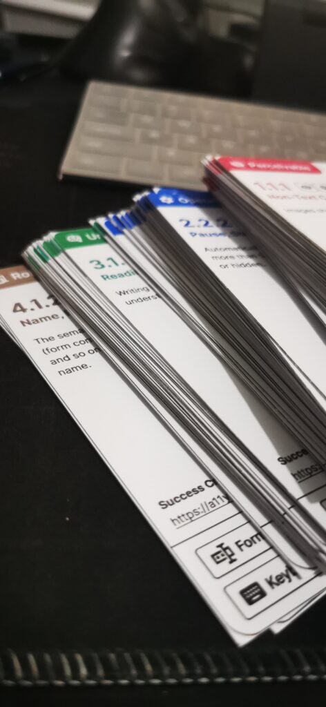 A stack of the WCAG flash cards separated by principles, each with its own color